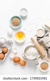 Baking Homemade Bread On White Kitchen Worktop With Ingredients For Cooking, Culinary Background, Copy Space, Overhead View