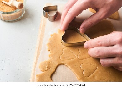 Baking ingredients and kitchen utensils on a white background top view. Female or man hands preparing heart sugar cookies. Baking sugar cookies. Flour, eggs, sugar, spices on kitchen table. Flat lay. - Powered by Shutterstock