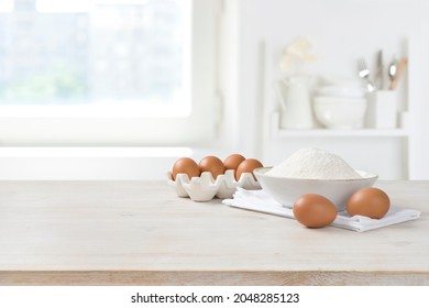 Baking ingredients on wooden table over defocused kitchen window background - Shutterstock ID 2048285123