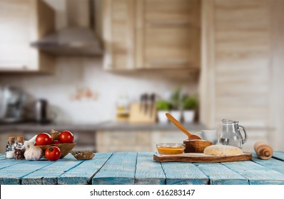 Baking ingredients placed on wooden table, ready for cooking. Copyspace for text. Concept of food preparation, kitchen on background.