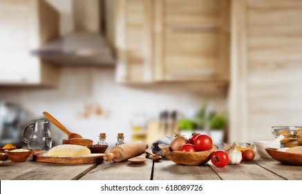 Baking ingredients placed on wooden table, ready for cooking pizza. Copyspace for text. Concept of food preparation, kitchen on background.