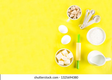 Baking Ingredients And Tools On Trendy Bright Yellow Background - Flour, Eggs, Sugar, Milk, Butter, Layout, Flatlay Top View Copy Space