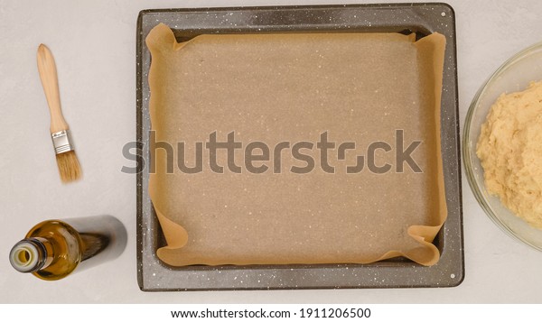 Baking pan covered with parchment paper, close up\
baking process, flat lay
