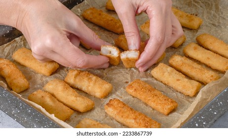 Baking pan with fish sticks close up on the kitchen table. Crunchy delicious lightly breaded with  bread crumbs fish sticks close-up - Shutterstock ID 2233867739