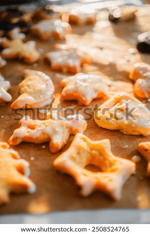 Baking Paper with Batch of Freshly Baked Biscuites with Sugar Coat and Springles in Different Forms for Christmas Extreme Close Up
