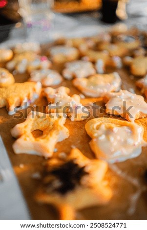 Baking Paper with Batch of Freshly Baked Biscuites with Sugar Coat and Springles in Different Forms for Christmas Isolated