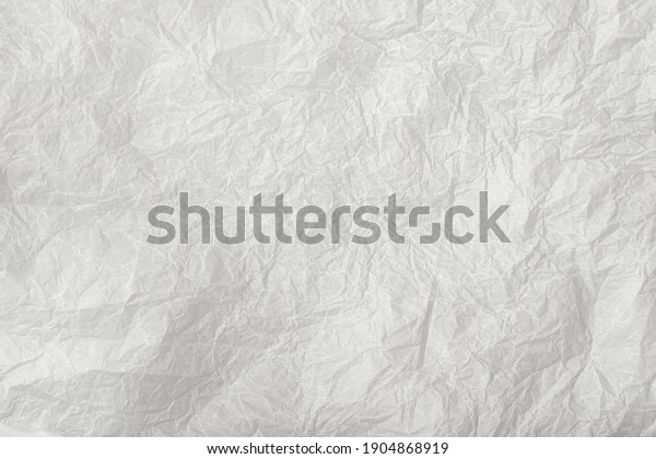 Baking paper sheet isolated on white\
background, top view. Parchment for baking\
culinary.