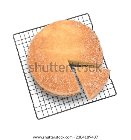 Baking rack with tasty sponge cake isolated on white, top view