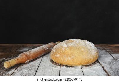 Baking Round Bread. Fresh, Delicious Bread On A Table Covered With Flour With A Roller Pin. Copy Space For Design Mock Up Baking Bread.