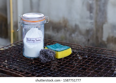 Baking Soda And Cleaning Tools On  Rusty Barbecue Grill