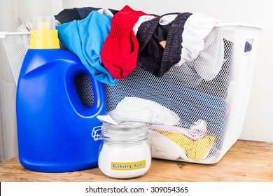 Baking Soda With Detergent And Pile Of Dirty Laundry