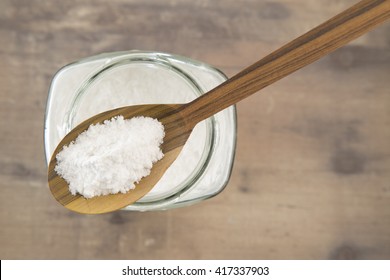 Baking Soda In Glass Bowl And Wooden Spoon