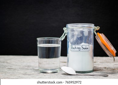 Baking Soda In Jar, Spoonful And Glass Of Water 