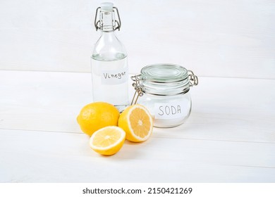 Baking Soda In Jar, Vinegar, Lemon On A White Background. The Concept Of Removing Stains On Clothes 