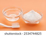 Baking soda, toothbrush and water for cleaning.