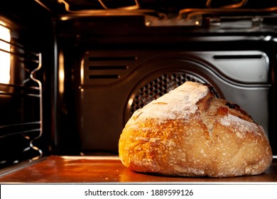 Baking sourdough bread in an oven. - Shutterstock ID 1889599126