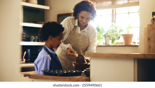 Baking, teaching and child with mother in kitchen for skill development with chocolate cupcakes. Learning, bonding and boy kid cooking cookies, muffins or dessert with chef mom together in home. - Powered by Shutterstock