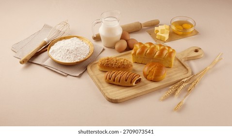Baking tools, milk, eggs, cheese, and assorted ingredients arranged on a fabric backdrop, creating a cozy and homemade kitchen vibe