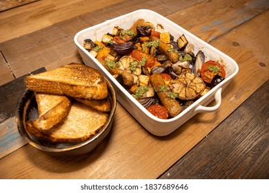 A Baking Tray Of Sausages And Vegetables With Tarragon Relish