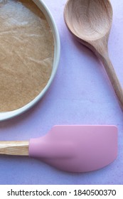 Baking Utensils And A Lined Round Cake Tin