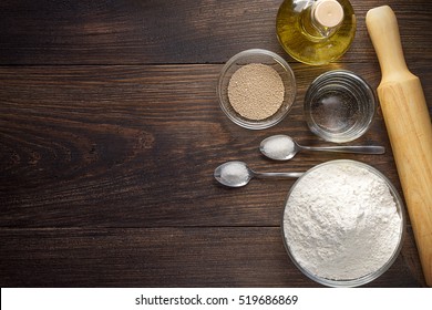 Baking Wooden Background With Ingredients For Pizza Dough. Baking Utensils On Dark Rustic Table, Top View.