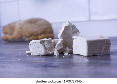 Baking Yeast For Baking. The High Content Of B Vitamins, Phosphorus, Iron, Zinc, Magnesium, Potassium, Selenium And Chromium. Cubes Of Yeast.Bread In The Background.