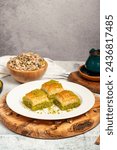 Baklava with pistachios on a wooden background. Turkish cuisine delicacies. Ramadan Dessert. local name kuru baklava