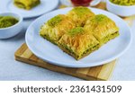 Baklava: A sweet pastry made of layers of filo dough filled with chopped nuts and sweetened with honey or syrup.