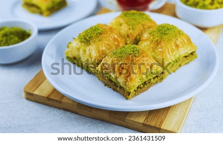 Baklava: A sweet pastry made of layers of filo dough filled with chopped nuts and sweetened with honey or syrup.