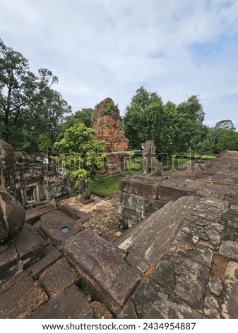 Bakong temple complex, several lesser spires of brick surround the main temple structure of stone, Siem Reap, Cambodia. 