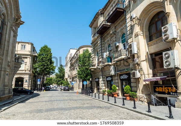 Baku, Azerbaijan – July 4, 2020. View of\
Abdulkerim Alizada street in Baku. View with commercial properties,\
cars and people.