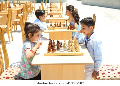 BAKU, AZERBAIJAN - JUNE 1 2019 : Kids festival . In park of Heydar Aliyev Center. Children play chess