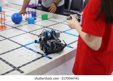 BAKU, AZERBAIJAN - MAY 28, 2022. Girl Control The Robot. Teacher Helps Them. Modern Training And Gadgets. Coding Class. EV 3.