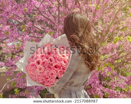 Similar – Woman arranges luxury bouquet of flowers