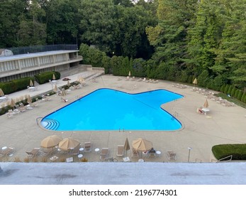 Bala Cynwyd, PA USA - August 11, 2022 : A 1960s Mid-century Modern Pool At A Suburban Apartment Complex Designed In The Shape Of An Arrowhead