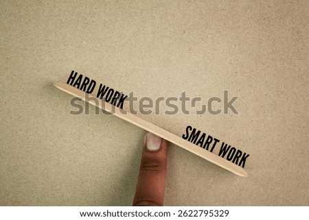 balance between the words hard work vs smart work. The word smart work is heavier. Smart work concept 