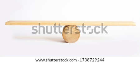 Balance concept, board on wooden top hat like balance isolated on white background.