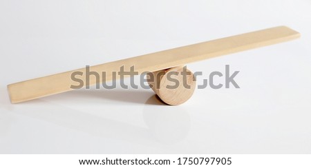 Balance concept, board on wooden top hat like balance isolated on white background.