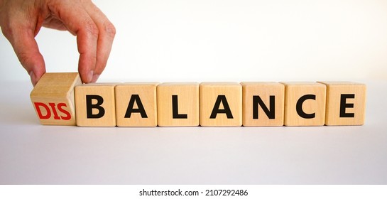 Balance or disbalance symbol. Businessman turns cubes and changes the word disbalance to balance. Beautiful white background, copy space. Business, balance or disbalance concept.