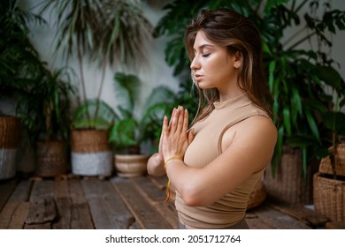 A balance of fortitude and a healthy lifestyle. Yoga in a fitness studio. The coach is engaged in aerobics and gymnastics flexible body. - Shutterstock ID 2051712764