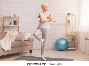 Balance In Life. Senior Woman Doing Yoga Tree Pose At Home, Free Space