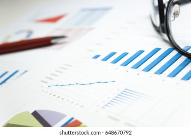 Balance sheet figures are statistics which including of pen, glasses and calculator. all information represent profit and cost. - Financial and accounting analysis concept.