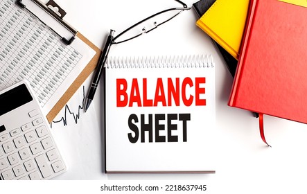 BALANCE SHEET Text On A Notebook With Clipboard And Calculator On White Background