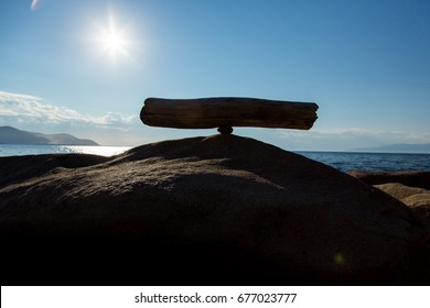 Balance of a stick on a stone - Shutterstock ID 677023777