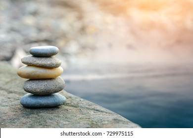 Balance stone with spa on river coast