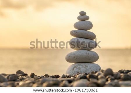 Balance stones close-up on the beach at sunrise