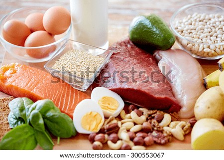 balanced diet, cooking, culinary and food concept - close up of different foodstuffs on table