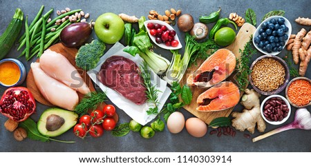 Balanced diet food background. Organic food for healthy nutrition, superfoods, meat, fish, legumes, nuts, seeds and greens 