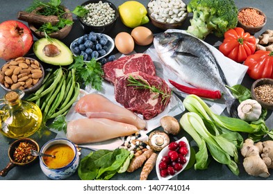 Balanced Diet Food Background. Selection Of Various Paleo Diet Products For Healthy Nutrition. Superfoods, Meat, Fish, Legumes, Nuts, Seeds, Greens And Vegetables