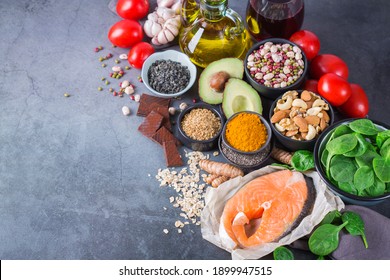 Balanced Diet Food Concept. Assortment Of Healthy Food Low Cholesterol, Spinach Avocado Red Wine Green Tea Salmon Tomato Flax Chia Seeds Turmeric Garlic Nuts Olive Oil